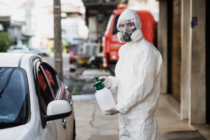 Delta dm man in protective suit and mask sprays disinfectan 2023 11 27 05 28 12 utc small